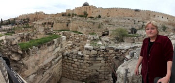 Dr. Eilat Mazar in front of a section of the excavated corner tower.