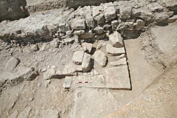 View of the remnants of the podium, the temple's façade and some steps. The long wall in the background belongs to the church whose foundations were built on the remains of the temple. (Photo: Gaby Laron)